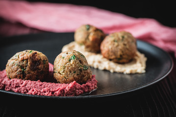 Arabic food, Falafel Humus - Delicious humus with falafel, beautifully arranged on a black plate