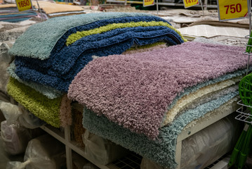 Pile of different carpets in a home decoration mall