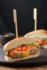 Tasty grilled home made burgers cooking with beef, tomato, cheese, cucumber and lettuce