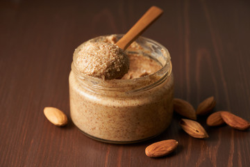 almond butter, raw food paste made from grinding almonds into nut butter, side view