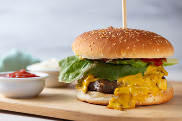 Tasty grilled home made burgers cooking with beef, tomato, cheese, cucumber and lettuce