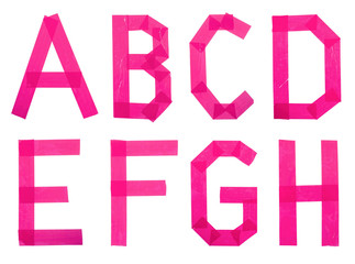 Set of pink letters of the English alphabet from scotch tape on a white background