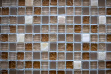 Brown ceramic mosaic on the wall as background