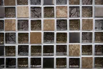 Yellow and dark glass mosaic on the wall as background