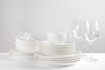 Fototapeta na wymiar Set of clean dishes on white table
