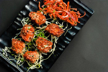 Indian shrimps served in a restaurant with a salad