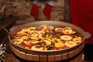 Large cauldron with tasty mulled wine at winter fair