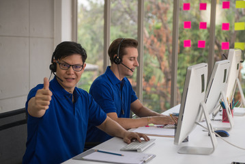 Cute young businessmen and colleagues in the call center office