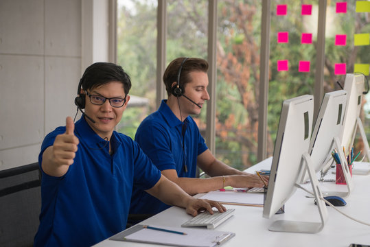 Cute young businessmen and colleagues in the call center office