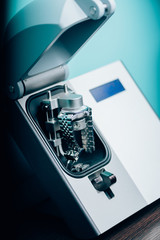 Selective focus of mechanical wristwatch in watch press on table