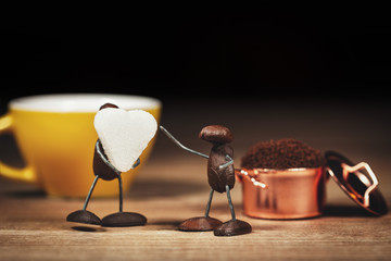 coffee bean figures with a cup of coffee and sugar cubes