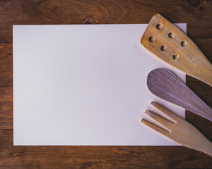 An invitation to cook created with wooden food utensils.