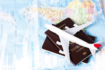 Model planes and thai passports for tourism on the world map.Travel planning concept on map