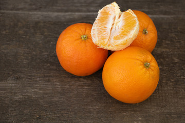 Oranges on wooden background. The benefits of oranges