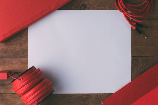 Invitation Composed Of Red Things With A Wooden Background.