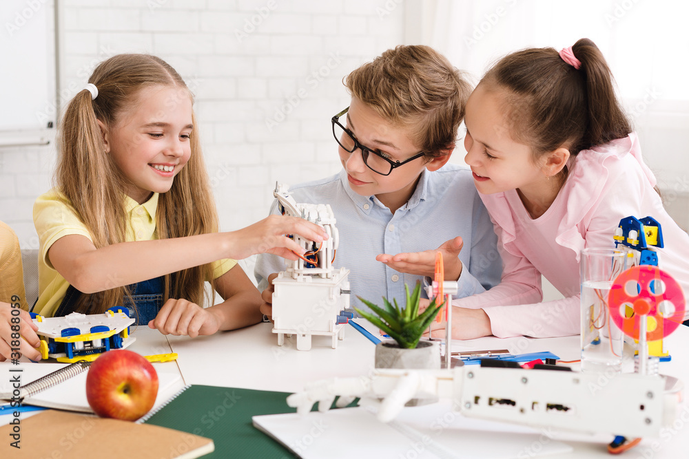 Poster school children creating robot together at lesson