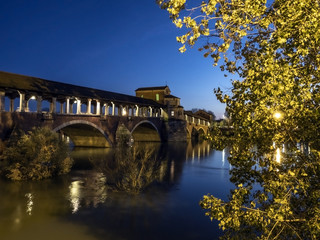 Fototapeta na wymiar View of Ponte Vecchio bridge during the flooding of Ticino river in Pavia, Italy