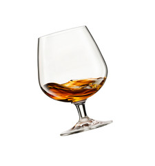 Swirling whisky glass on white