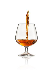 Pouring whisky into glass on white