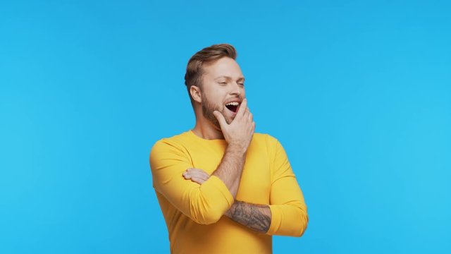 Expressive young man over vibrant background. Portrait of handsome person.