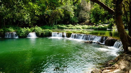 Fototapeta na wymiar Green waterfall (Chet Sao Noi waterfall) in Thailand.