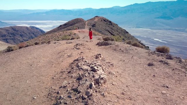 Death Valley National Park, California, Woman walks on top of Dante's View in Death Valley National Park in California. It is one of the hottest places in the world