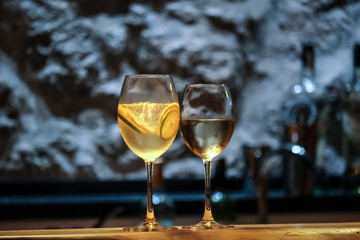glass of white wine on wooden table