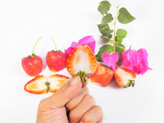 red ripe strawberry and finger isolated on white background.
