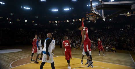 Basketball players on big professional arena during the game. Tense moment of the game.