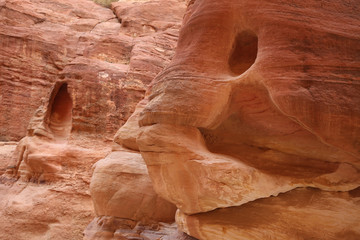 Red rock with a face, as you walk down the Siq towards Petra, Jordan.