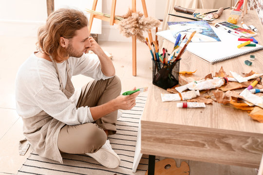 Young Male Artist Painting At Home