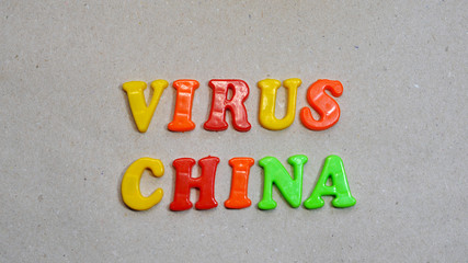 Chinese coronavirus colored words are written on a craft background. Chinese virus concept
