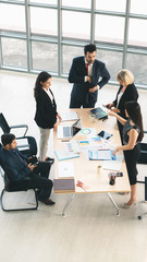 vertical business background of group of businesspeople around meeting table and having business...