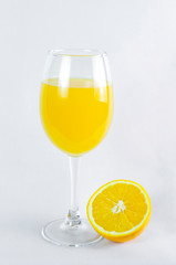 glass of orange juice, orange and orange leaves, on bright background