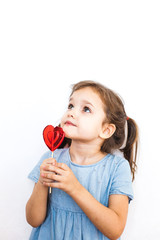 little girl holding a Lollipop in the shape of a heart, lovers, Valentine's day, family and heart