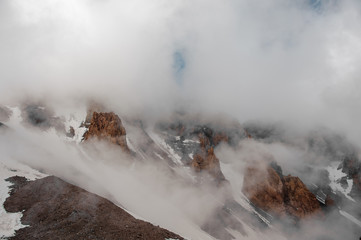 Mountain sides almost invisible behind the fog