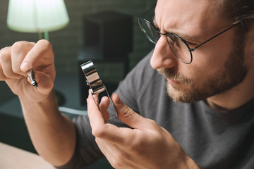 Jeweler examining gemstone in workshop