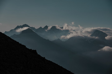 Obraz premium Silhouette of a mountain slope in front of ridge