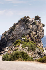 Fototapeta na wymiar The small church on the hill above the sea( Skopelos island, Greece)