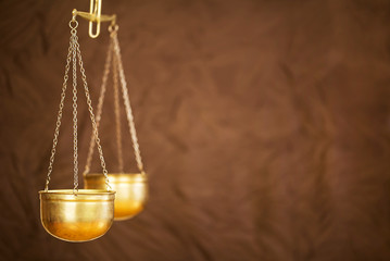 Liberty, legal, law concept, gold weighing scales of justice on brown background with copy space