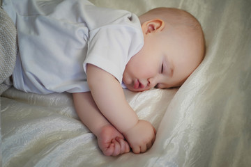 baby sleeps on a white background. Newborn boy sleeping close-up