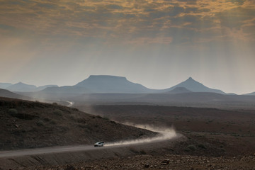 safari car traveling fast through a scenic landscape