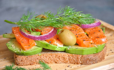 Healthy whole grain bread toast with avocado and salmon. Healthy Nutritions Dish. Salmon sandwich