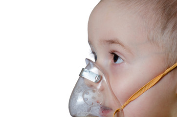 Little boy does inhalation. Treats pneumonia with a nebulizer