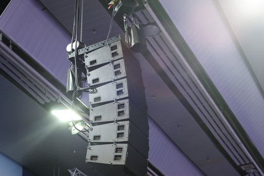 Professional sound speakers suspended from the ceiling. Installation of equipment for performances or concerts