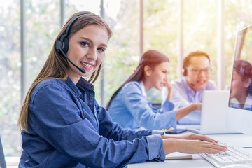 Group of call center operators at work - Call center and customer service concept.	
