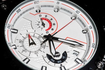 Fototapeta premium Luxury sport chronograph white Analog Men's Watch silver red steel for men luxury on black background - detail view - closeup