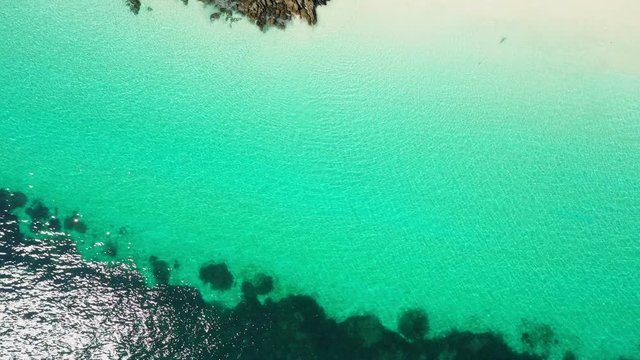 Aerial top view of ocean waves, beach and rocky coastline and beautiful forest. Nyaung Oo Phee Island Myanmar