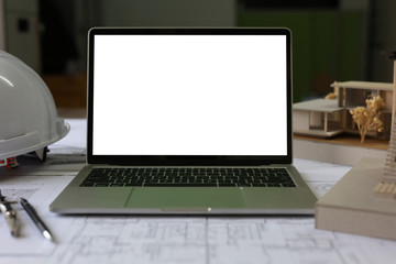 Top view, Blueprints Plans laptop and accessories on table.