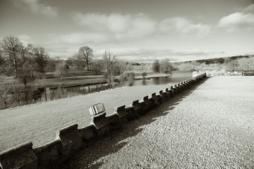 View Across a Lake with Woodland Trees in the Background on a Sunny Winter Morning.